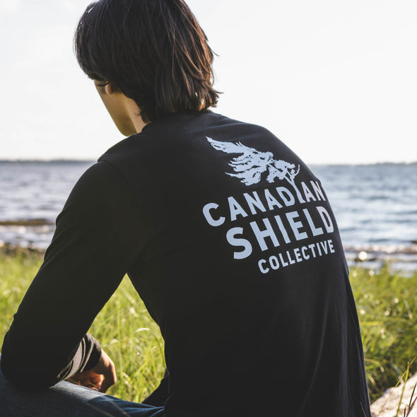 BORN ON THE SHIELD  SUNSET WITH CANADIAN SHIELD COLLECTIVE LOGO ON THE BACK (Unisex Long Sleeve Tee - black only)