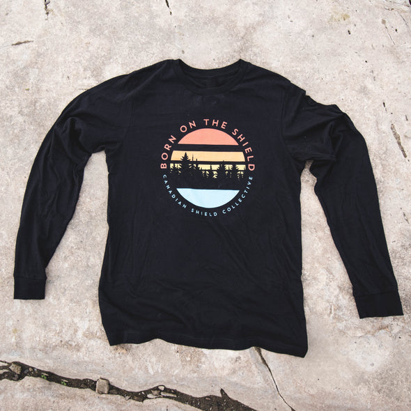 BORN ON THE SHIELD  SUNSET WITH CANADIAN SHIELD COLLECTIVE LOGO ON THE BACK (Unisex Long Sleeve Tee - black only)